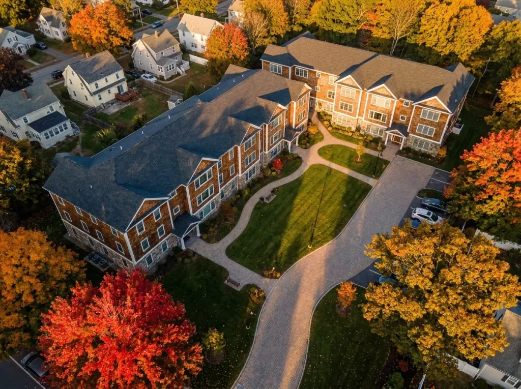 Aerial view of a North Shore Massachusetts multi-family development with organized site and mature landscaping showing scale of acoustic construction.